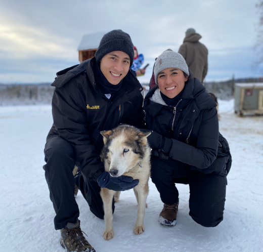 Couple in the snow with their dog