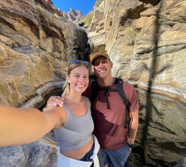 Couple taking a selfie while on a hike in a rocky terrain