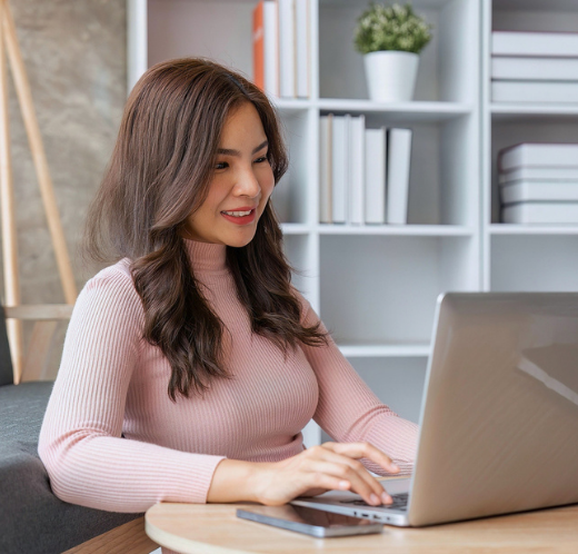 Woman sitting at a desk working on her laptop