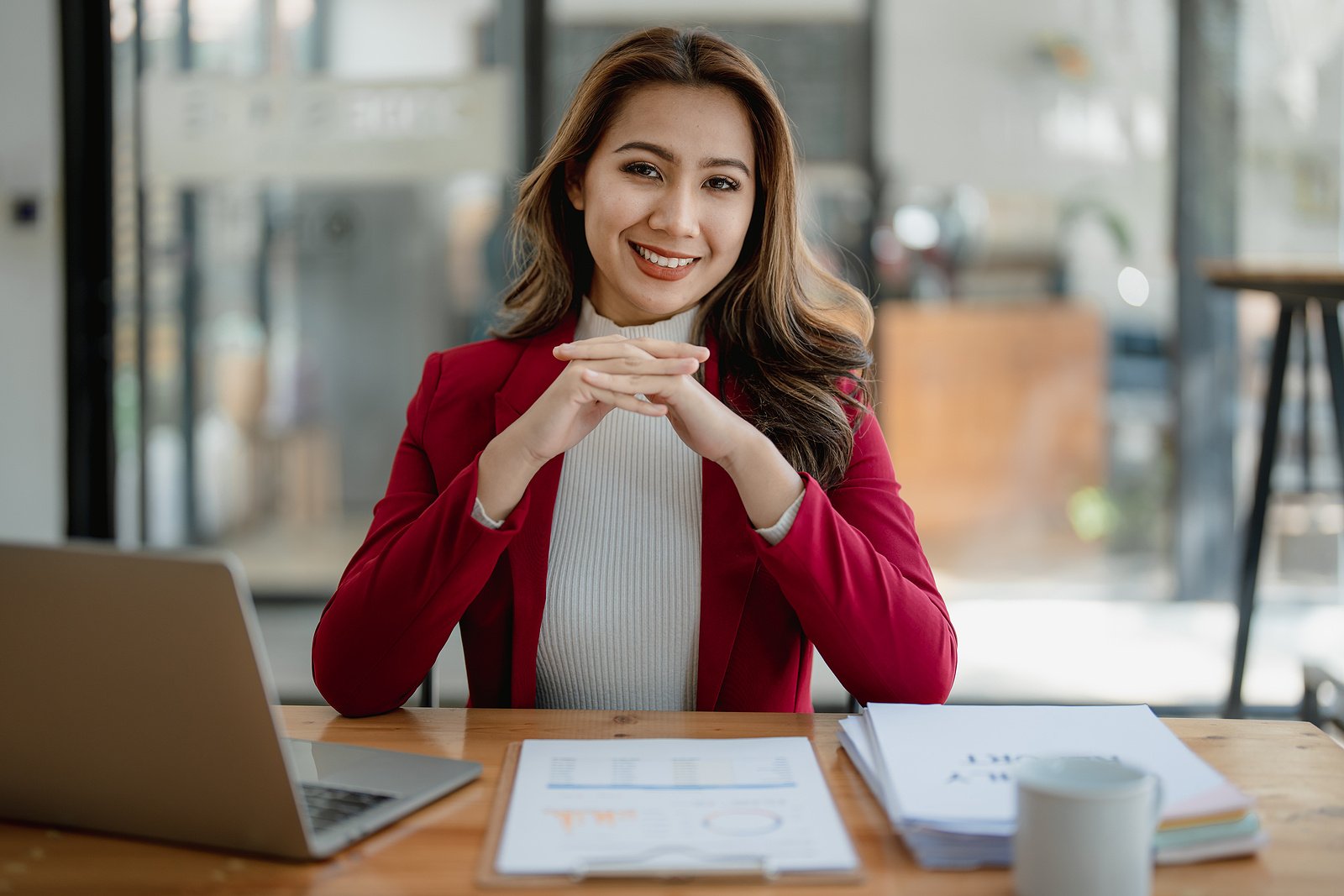 Therapy recruiter sitting at her desk smiling at the camera