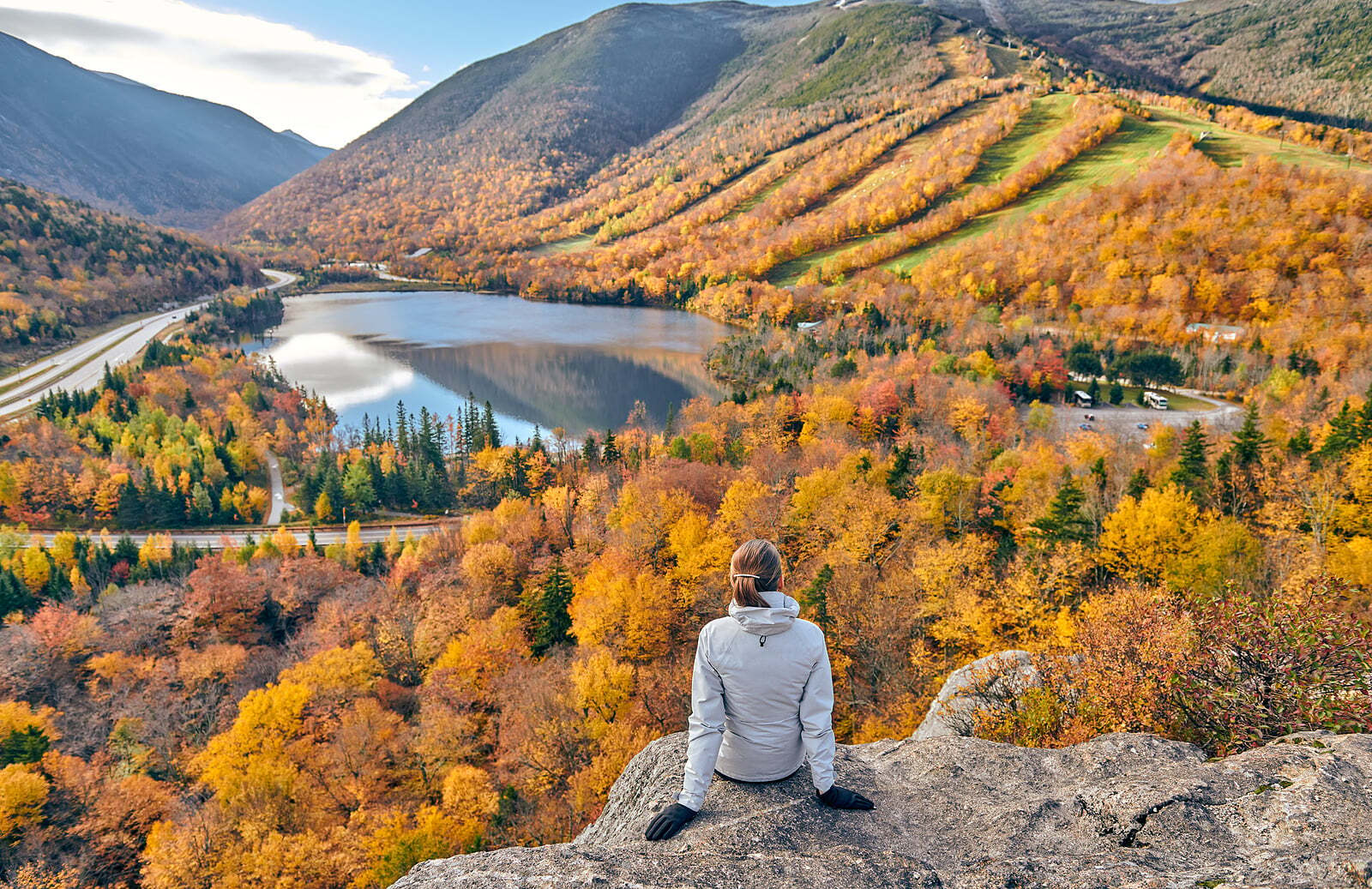Travel therapist on a hike in the fall enjoying the view
