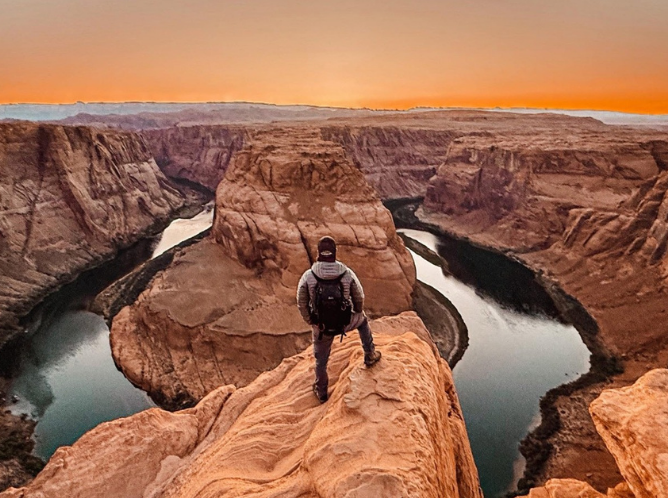 Man looking out at red rocks scenery