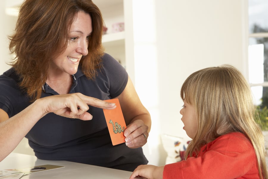 Travel speech therapist working a child