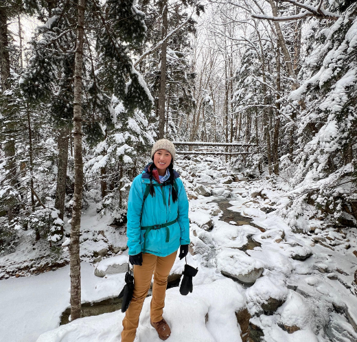 Woman standing in a snowy forest