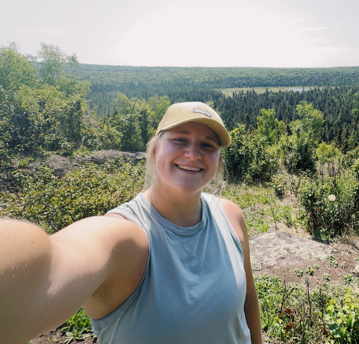 Woman taking a selfie in a forest