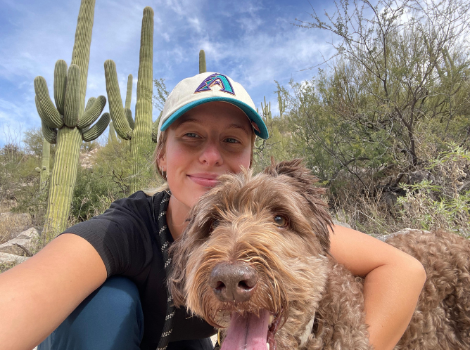 Woman taking a selfie with her dog in the desert