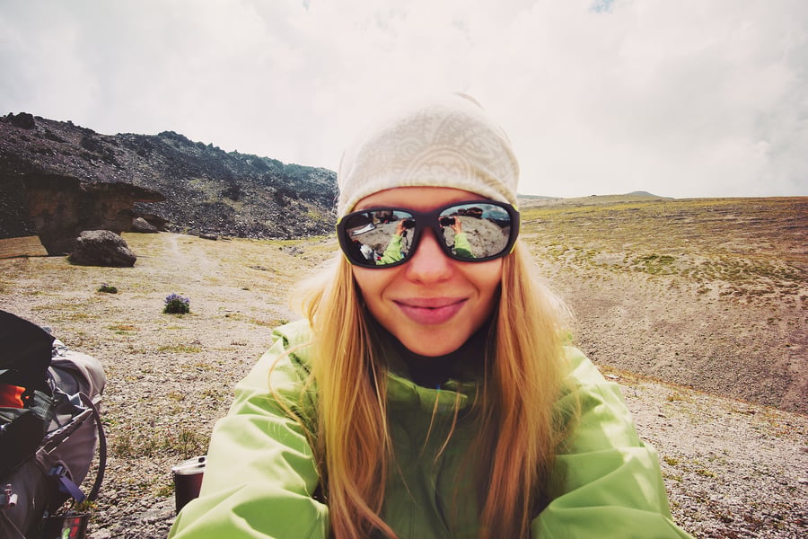 Woman taking a selfie on a mountain peak