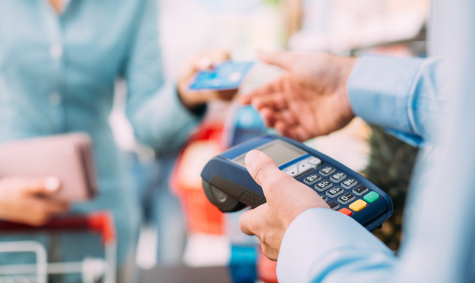 bigstock-Woman-At-The-Store-Checkout-177015373