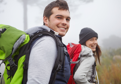 Couple backpacking with hiking gear