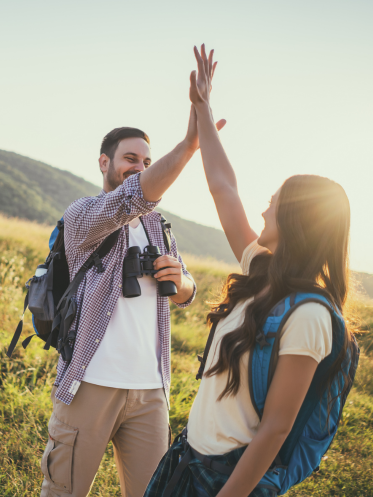 Couple high fiving while on a hike