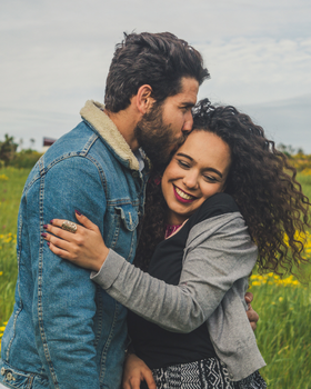 Couple holding each other in a field of grass-1